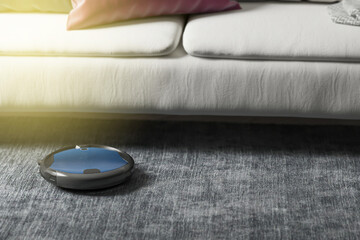 Robots vacuums cleaners on carpet in living room for cleaning pet hair and dust.