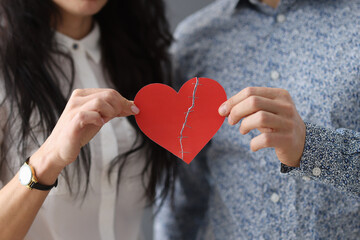 Man and woman are holding glued heart