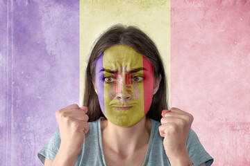 Flag of Andorra painted on a face of a anxious young woman