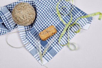 Biscuits and tape measure on a white background with tablecloth