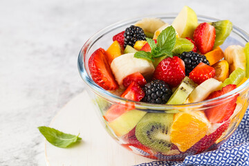 Delicious fruit salad on a plate on table.