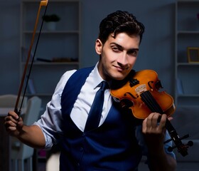 Young musician man practicing playing violin at home