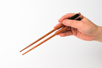 Wooden chopsticks on white background