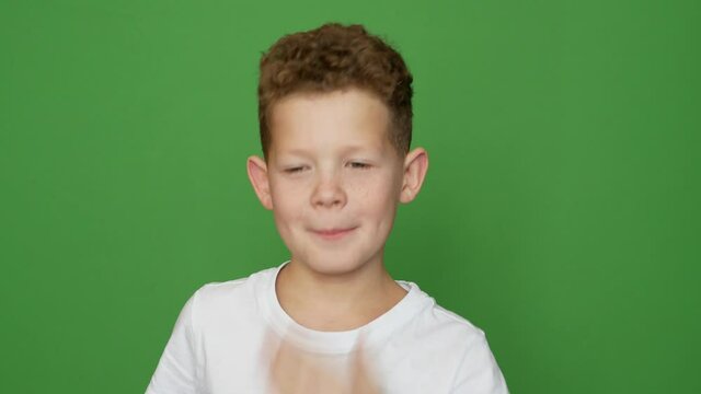 boy kinky yawns covers his mouth with his hand background greenscrean