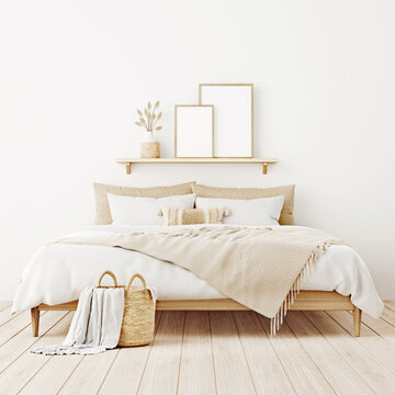 Vertical poster mockup in boho bedroom interior with two wooden frames on shelf above bed, beige blanket, cushion with tassels, dried grass and basket on white wall. 3d rendering, 3d illustration