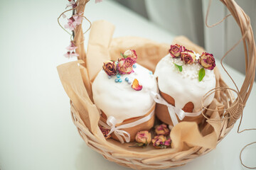 Woman hands holding traditional russian easter cake on table. The decorarion of kulich are the flower are eating on spring holiday