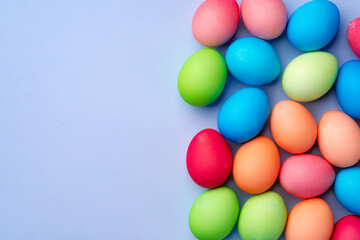 Colorful Easter eggs on blue background top view