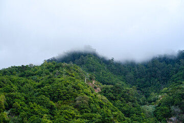mountain peak covered by clouds