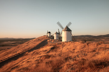 Fototapeta premium Windmills situed in Castilla la Mancha, Spain, captured during sunrise.