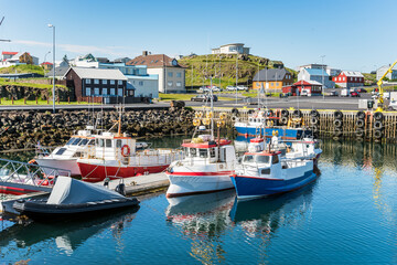 Fishing harbour in a colourful coastal village on a sunny summer morning. Stykkishólmur, Iceland.