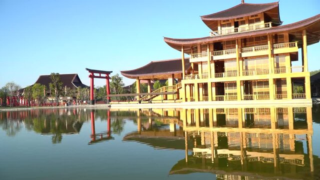 Hinoki Land building (Bann Mai Hom Hinoki) with red torii gate in Chiang Mai Thailand. Japanses building style beside the lake. New tourist attraction in Chiang Mai, Thailand.
