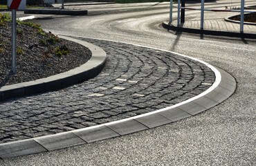 roundabout of paving of gray granite cubes in a rolled sill closer to the center. beveled concrete...