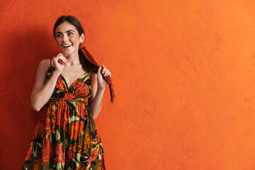 Obraz premium Beautiful young woman in summer dress posing