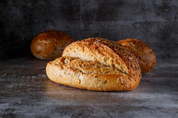 Assortment of baked bread on wooden table background Fresh fragrant bread on the table. Food concept.