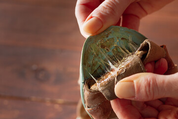 Old shoes with a torn sole. The glue stretches on the sole.