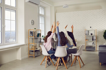Team of young people having a meeting in modern coworking space. Group of enthusiastic women...