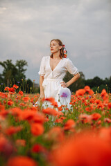 portrait of a girl in a field of poppies