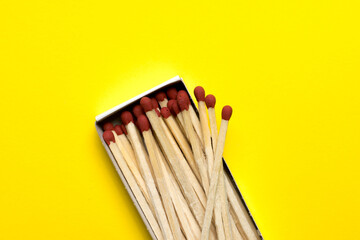 box with matches lies on a yellow background. space for text