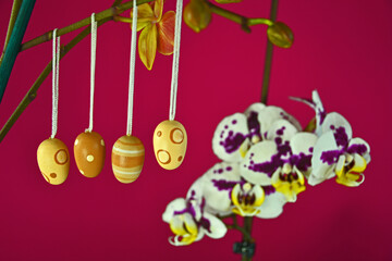 Easter eggs on flower on the red background