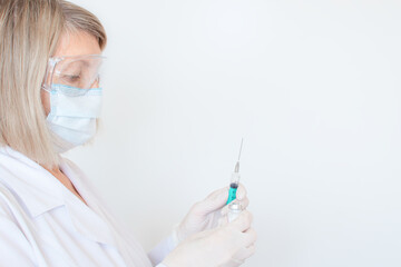 Adult doctor, nurse, infectious disease scientist hand in white protective gloves holds the flu, measles, coronavirus, covid-19 vaccination, prepares for vaccination. Medicine and concept, covid19.