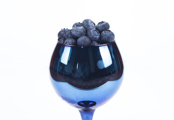 blue glasses with blueberries on a white background