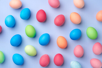 Colorful Easter eggs on blue background top view