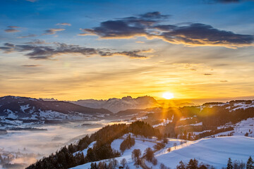 awesome winter landscape at sunset with  view from the Allgau Alps over the Bregenzer Wald in Austria to Mount Saentis in Switzerland