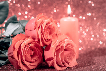 Fototapeta premium Valentine's day romantic card. Bouquet of roses and a candle on pink background.