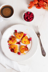 Breakfast on Valentine's Day - cheesecakes in the shape of hearts and red bouquet. 