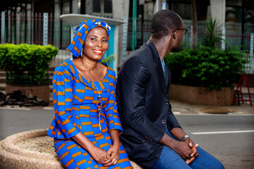 businessman and businesswoman sitting together on the street.