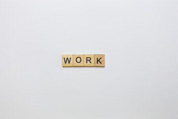 Wooden cubes, inscription on a white background - a robot. View from above.