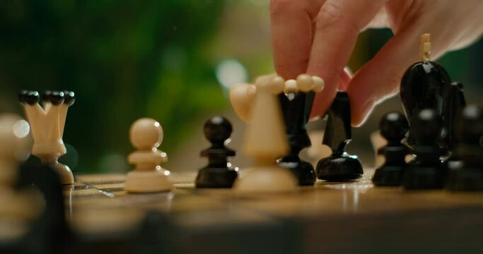 Close up to Chess Game with Gambit Opening. White Pieces Win with Checkmate. Sport and Hobby at Lockdown. 4K Cinematic Macro Pan Shot in Slow Motion with Wooden Chess Pieces
