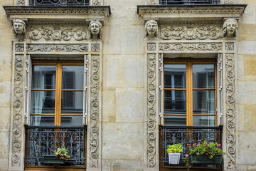 Traditional French house with typical balconies and windows. Paris, France.
