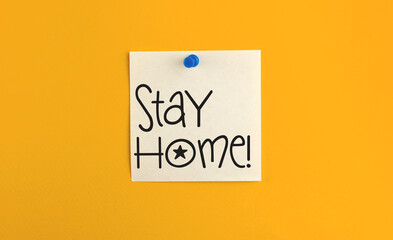 Stay home reminder pinned paper note, sticker, new normal concept banner, copy space and yellow background, flat lay