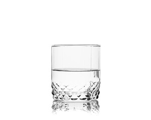 Whiskey glass with transparent liquid isolated on white background
