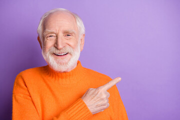 Photo of man indicate finger empty space proposition toothy smile wear sweater isolated on violet...