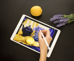 A girl's hand draws a still life picture with a pencil on an electronic tablet. The concept of inspiration, creativity, self-development, hobby, modern art