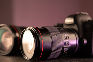 Close up in focus lens on the body of a professional digital camera copy space.