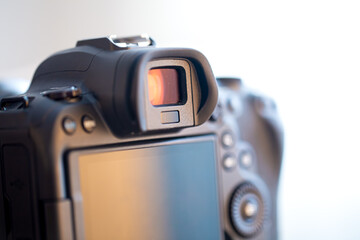 Close up part of a professional digital camera on a blurred background.