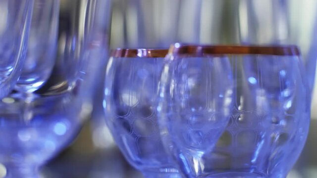 Serving table with many empty glass bocal ready for event party surrounded by blinking lights