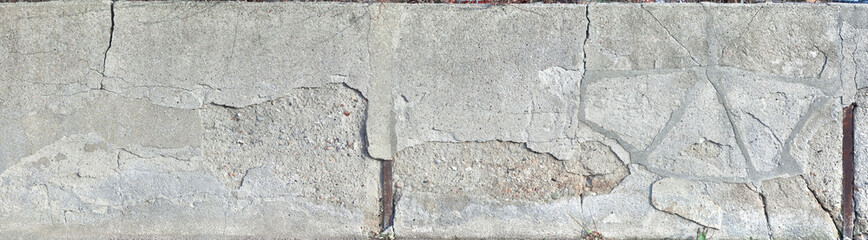 Old crumbling concrete wall in panoramic format.