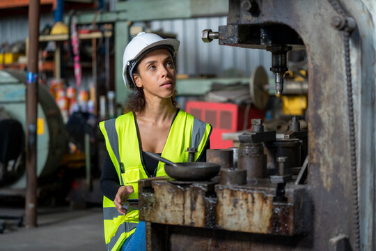 Factory female worker working and checking with clipboard in hands taking necessary notes at plant. - Powered by Adobe