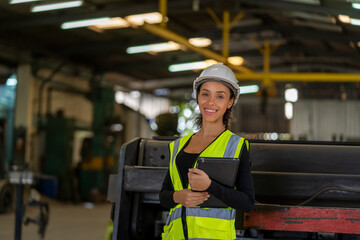 Factory female worker working and checking with clipboard in hands taking necessary notes at plant.