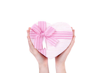 Gift box in the shape of a heart with a pink bow in your hands on a white background,top view