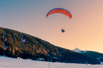  Paraglider attempting to land while sunset in Davos