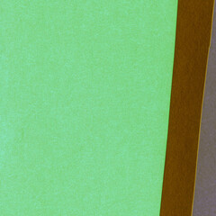 Fototapeta premium Green torn paper collage close-up. Texture made from various paper and cardboard parts. Damaged old paper background. Vintage blank wallpaper. Material design backdrop.