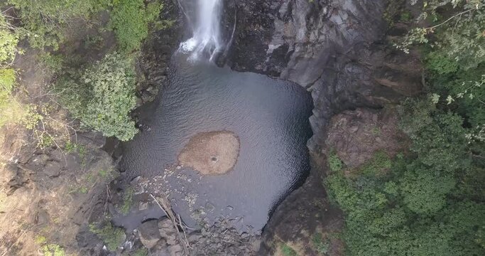 Quiet Lagoon At Mainapi Waterfall In Netravali Wildlife Sanctuary In South Goa, India. - Aerial Descending Shot