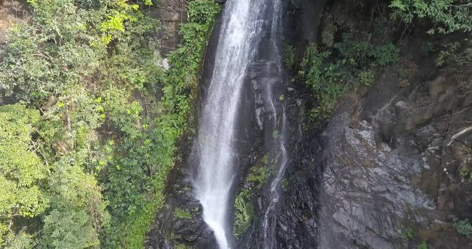 Rapids Flowing Down On Smooth Rocks From The Valley At Mainapi Waterfall In Netravali Taluka Of South Goa, India. - Aerial Drone Shot
