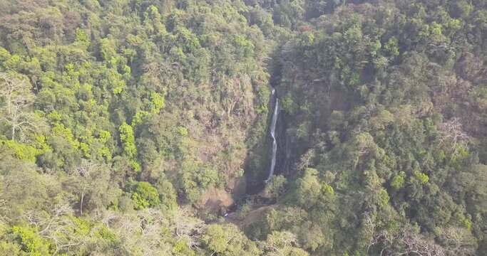 Falls Deep Into The Shaggy Forest At Netravali Wildlife Sanctuary In South Goa, India. - Aerial Wide Shot