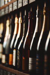 Bottles of champagne on the shelf, close-up image of alcoholic beverages in the wine cellar....